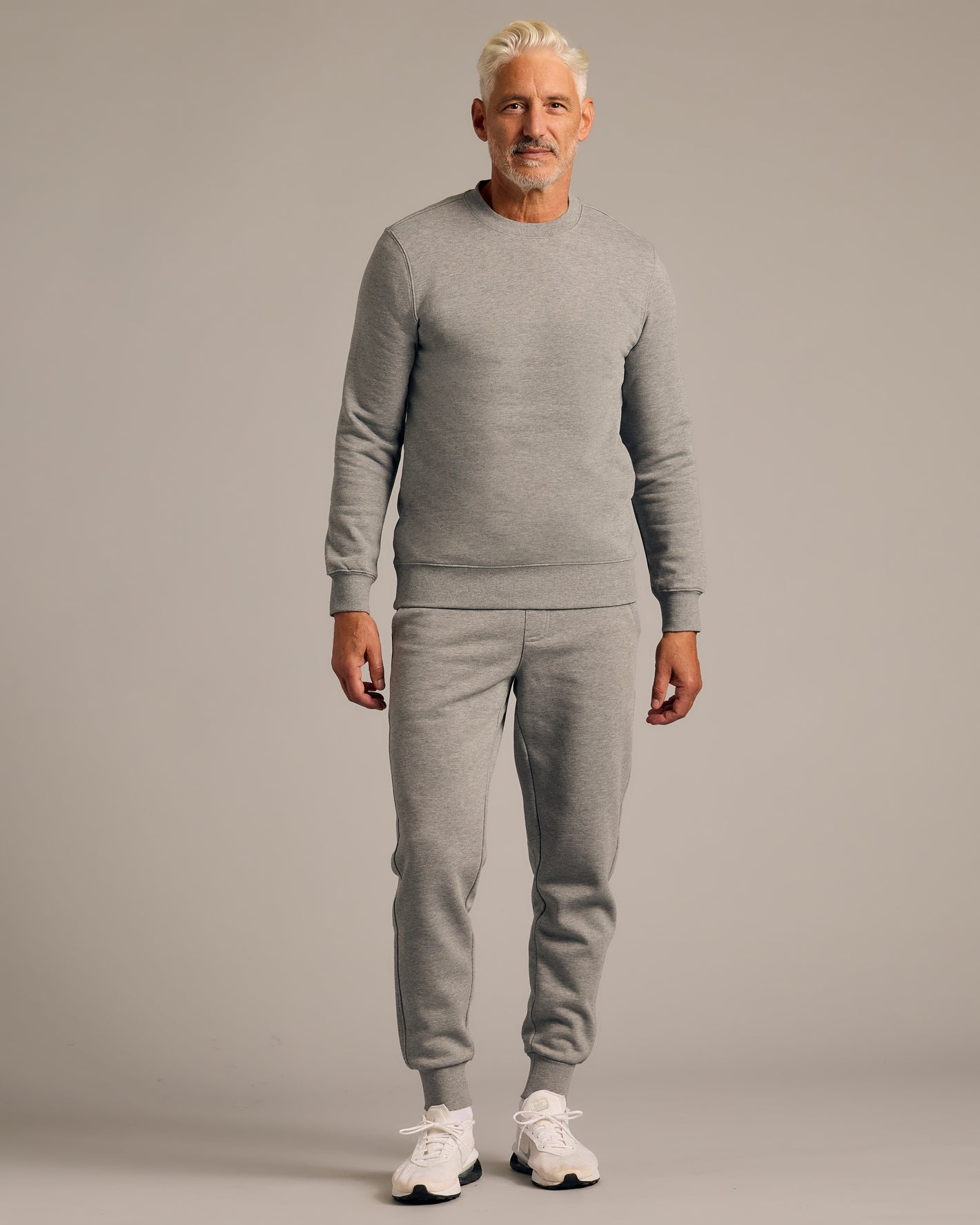 Man in Dark Heather Gray Fleece French Terry Pullover Crew Neck.