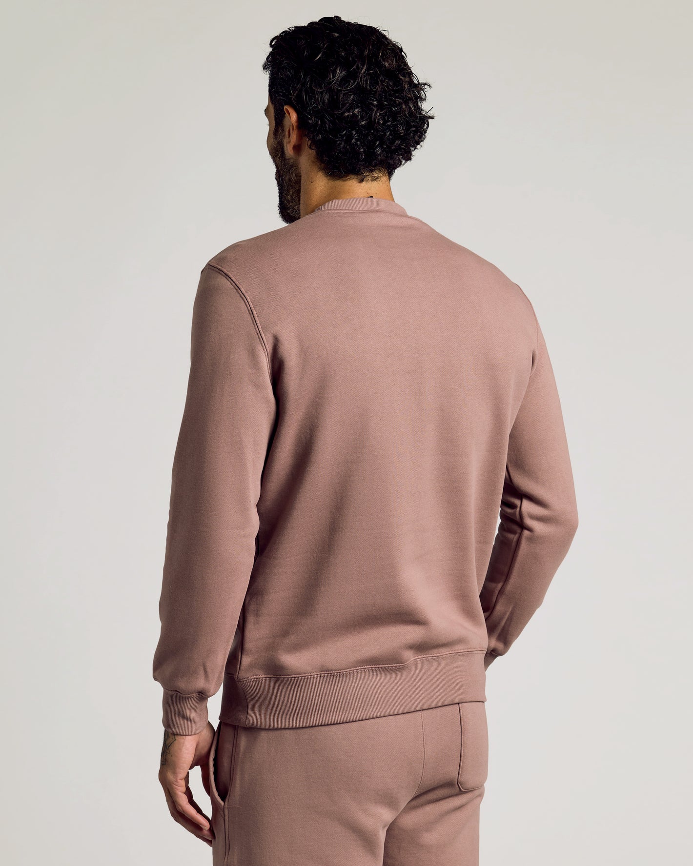 Man in Slate Mauve Fleece French Terry Pullover Crew Neck Sweatshirt.