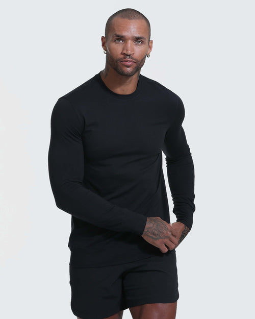 Black Active Comfort Crew Sweatshirt worn by tattooed man, showcasing its slim fit.
