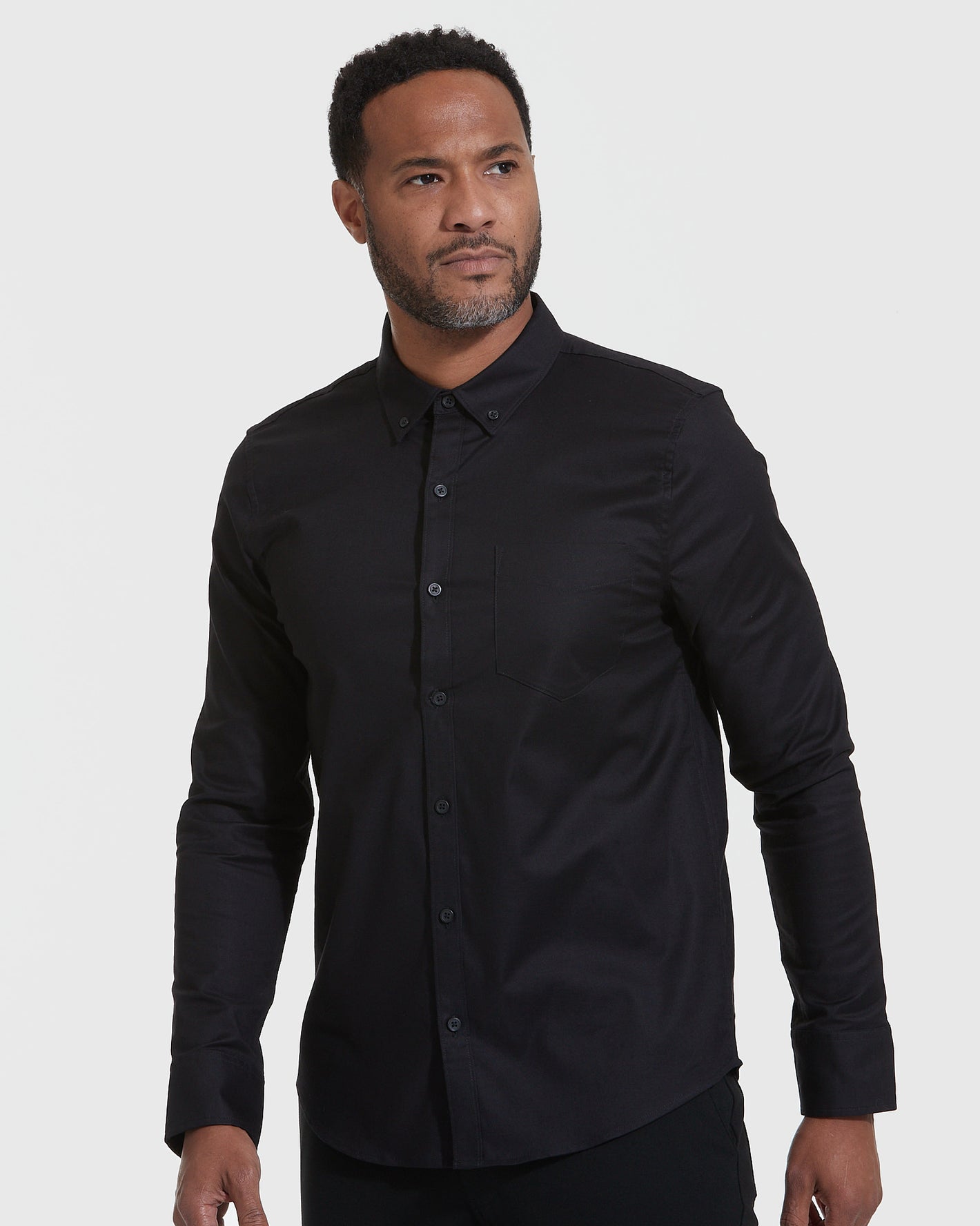 Man wearing Standard Stretch Oxford 3-Pack black shirt.