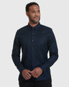 Navy Stretch Oxford Long Sleeve Button Up Shirt on man standing.