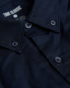 Navy Stretch Oxford Long Sleeve Button Up Shirt close-up, folded collar, buttons.