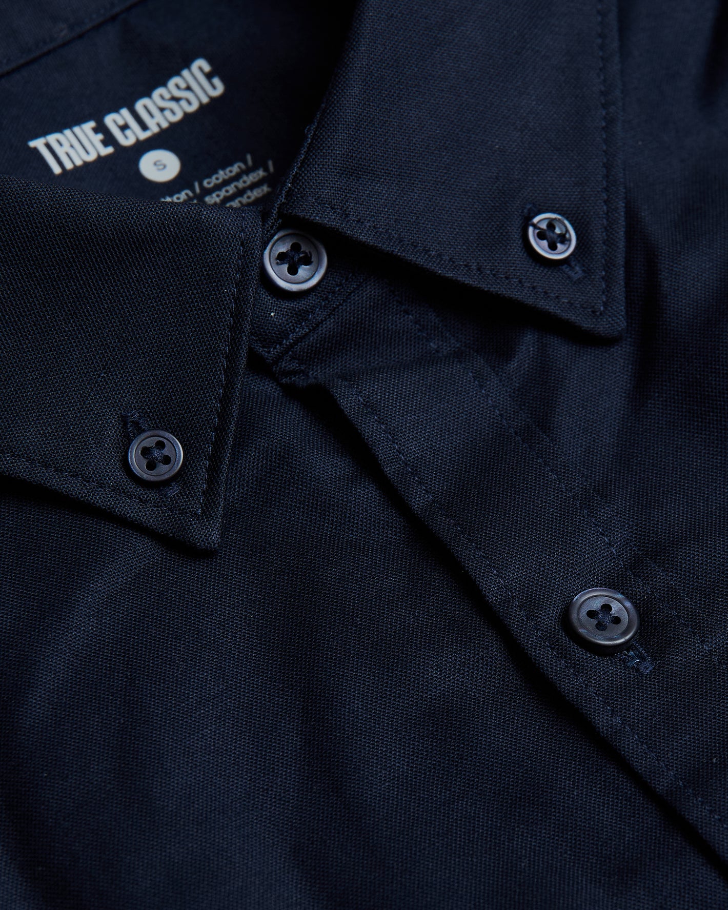 Navy Stretch Oxford Long Sleeve Button Up Shirt close-up, folded collar, buttons.