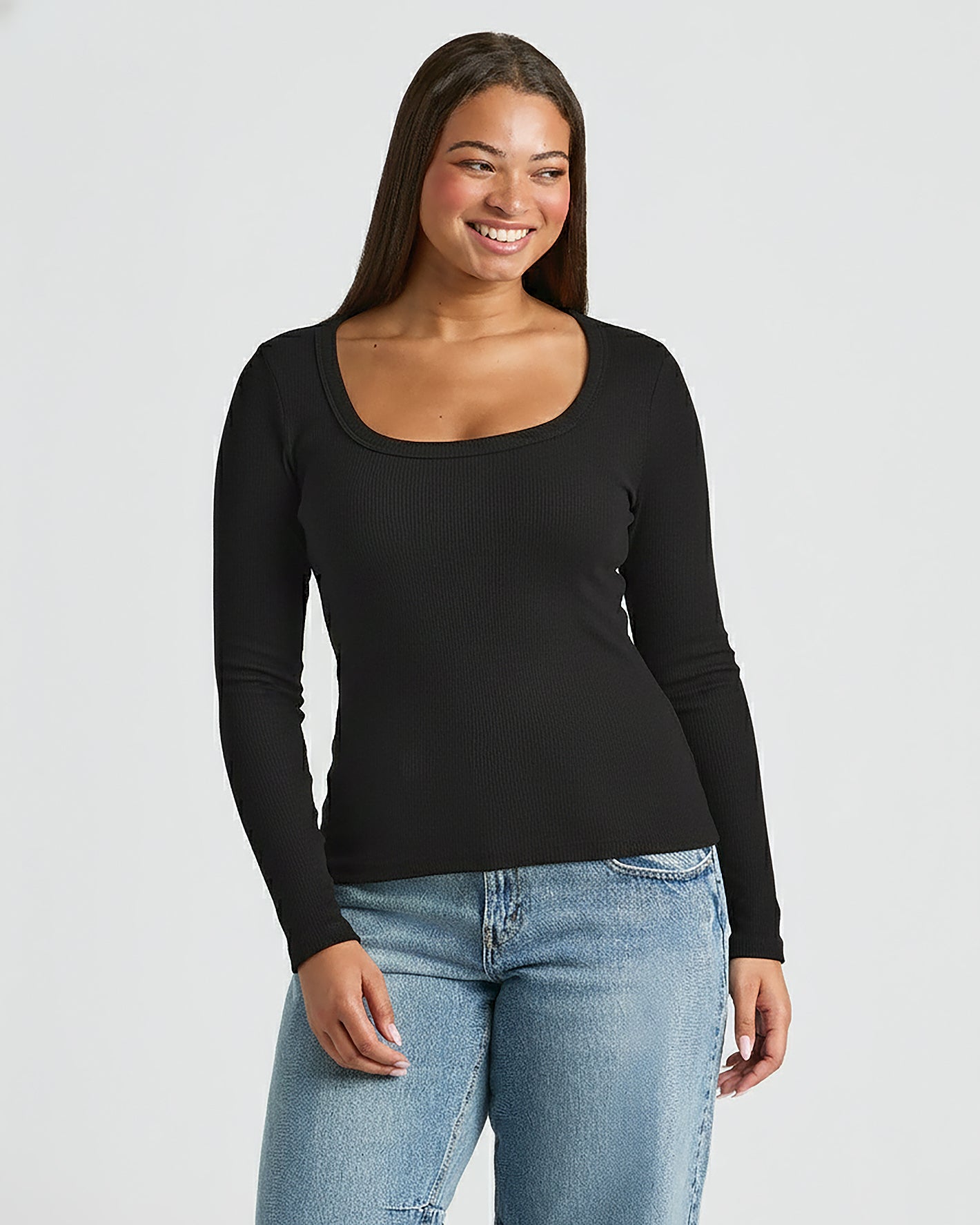 Woman in Womens Black Ribbed Long Sleeve Scoop Neck Tee.