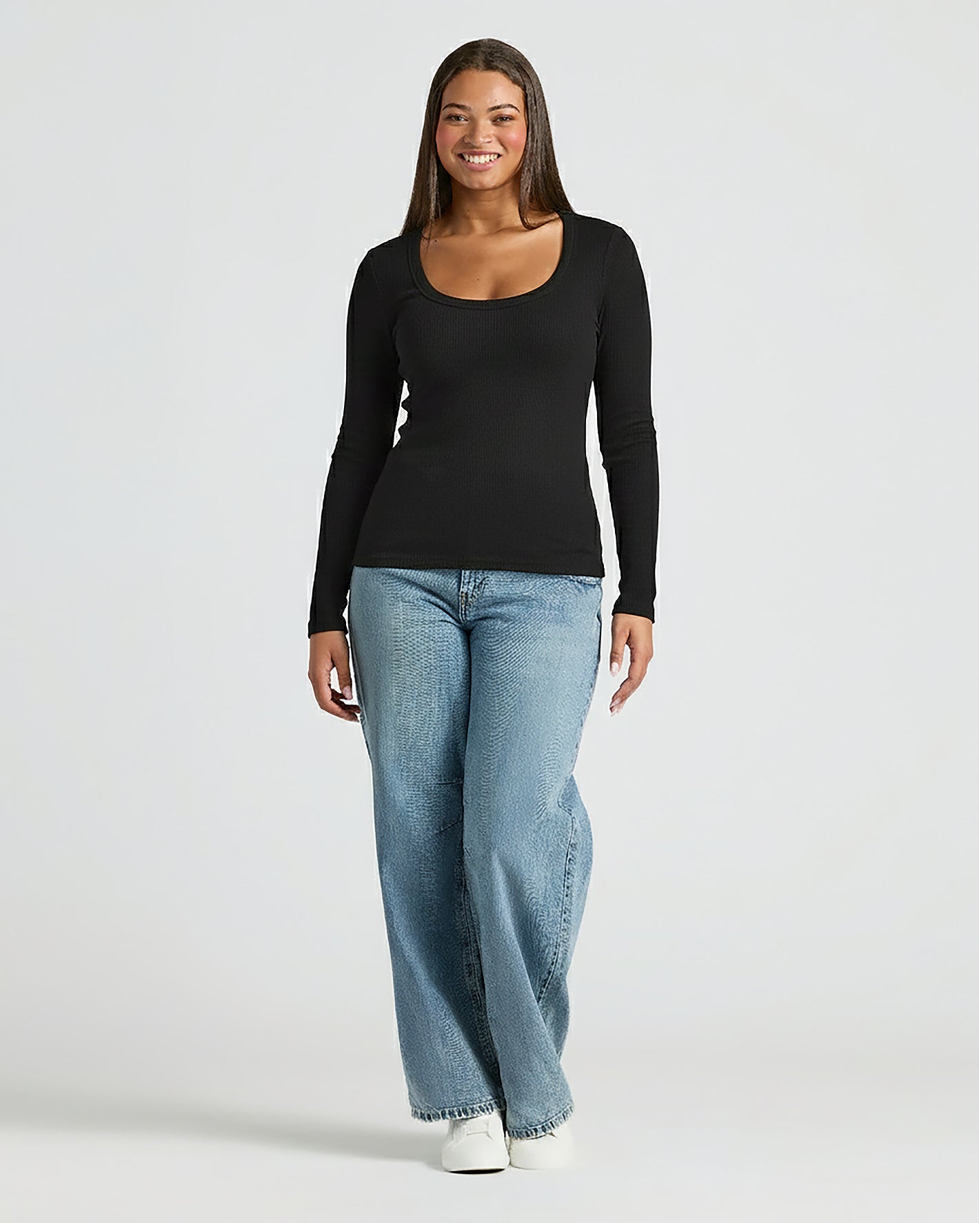 Woman wearing Womens Black Ribbed Long Sleeve Scoop Neck Tee.