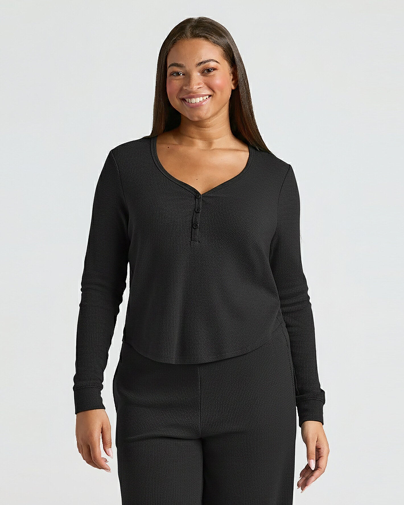 Woman modeling Womens Black Waffle Long Sleeve Boxy Henley set.