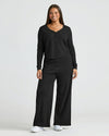 Woman in Womens Black Waffle Wide Leg Pants, modeling cozy lounge set.