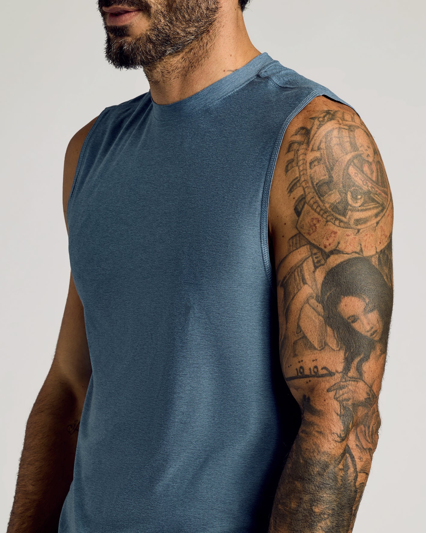 Baltic Sleeveless Active Muscle Tee on tattooed man’s upper body.