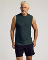 Man in Dark Heather Forest Sleeveless Active Muscle Tee and black shorts.