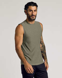 True ClassicMan wearing a Heather Military Green Sleeveless Active Muscle Tee with a fit build and tattooed arm, posing confidently against a plain background in men's basics style.