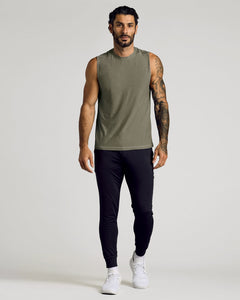 True ClassicMan wearing a Heather Military Green Sleeveless Active Muscle Tee paired with black joggers and white sneakers, showcasing a casual and athletic men's basics look.