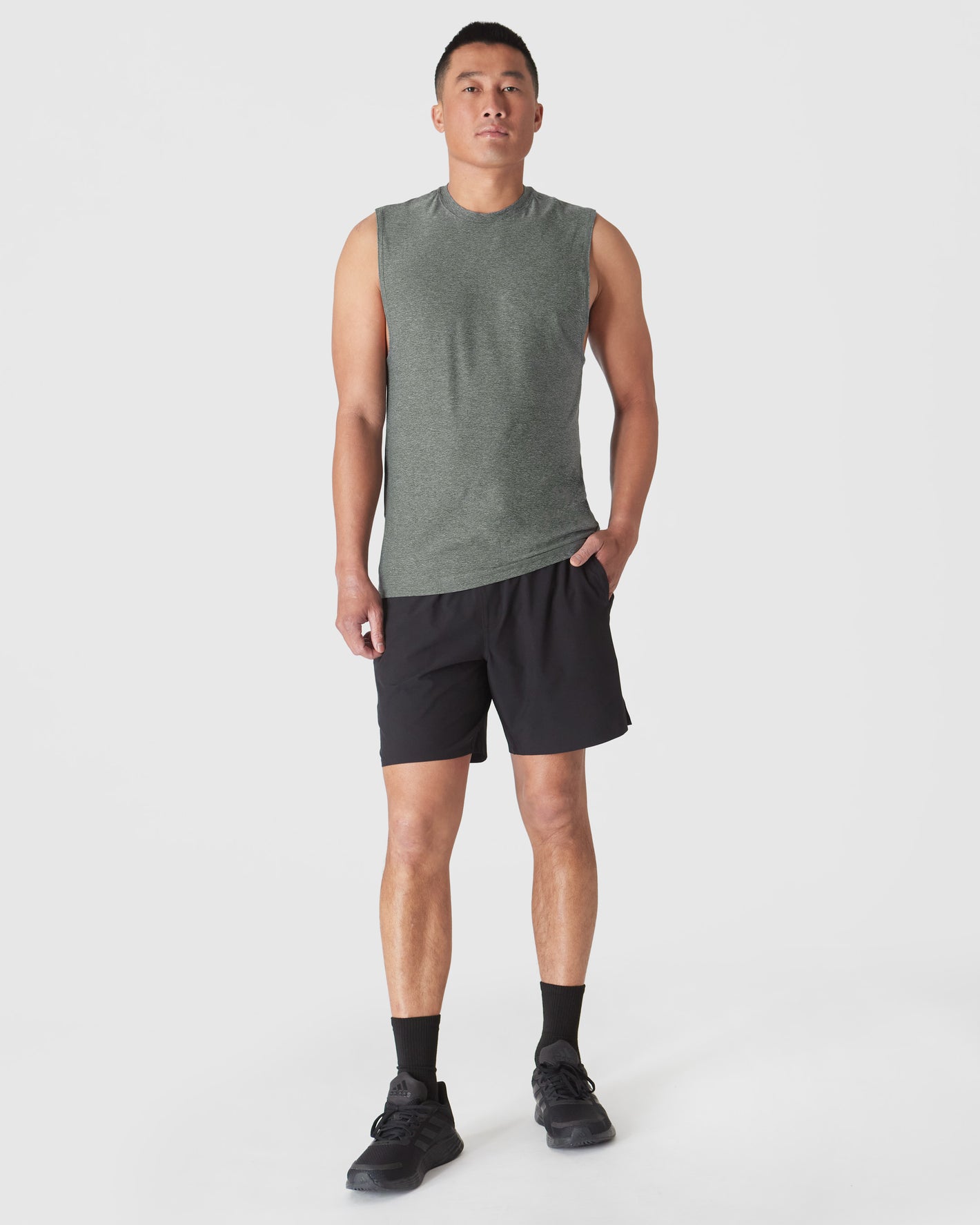 Heather Forest Sleeveless Active Muscle Tee on fit man, showcasing relaxed fit.