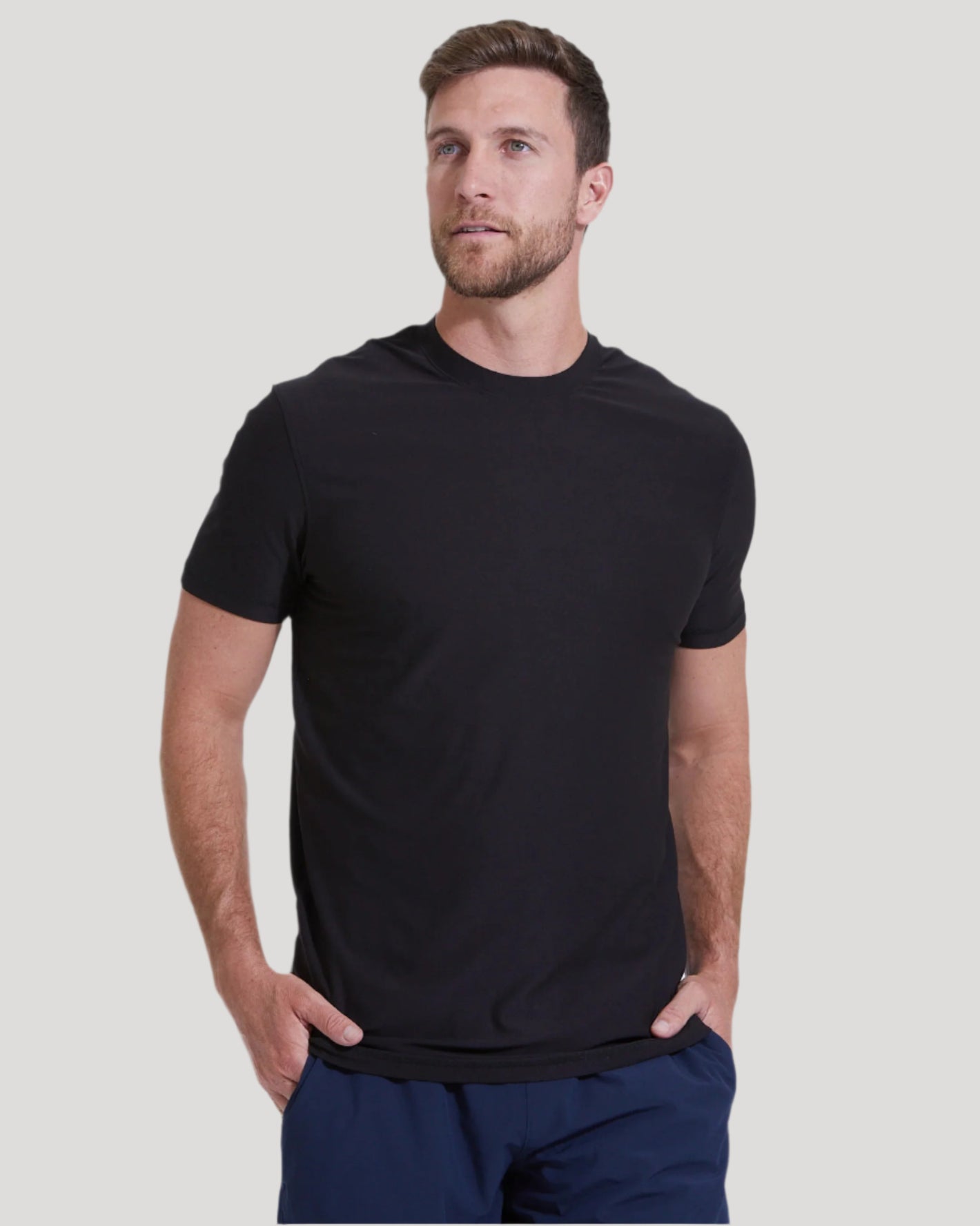Man wearing Black & White Tall Active Crew 6-Pack T-shirt, hands in pockets.