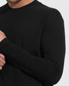 Person wearing Tall Classic Long Sleeve Crew, black, gently holds their wrist.