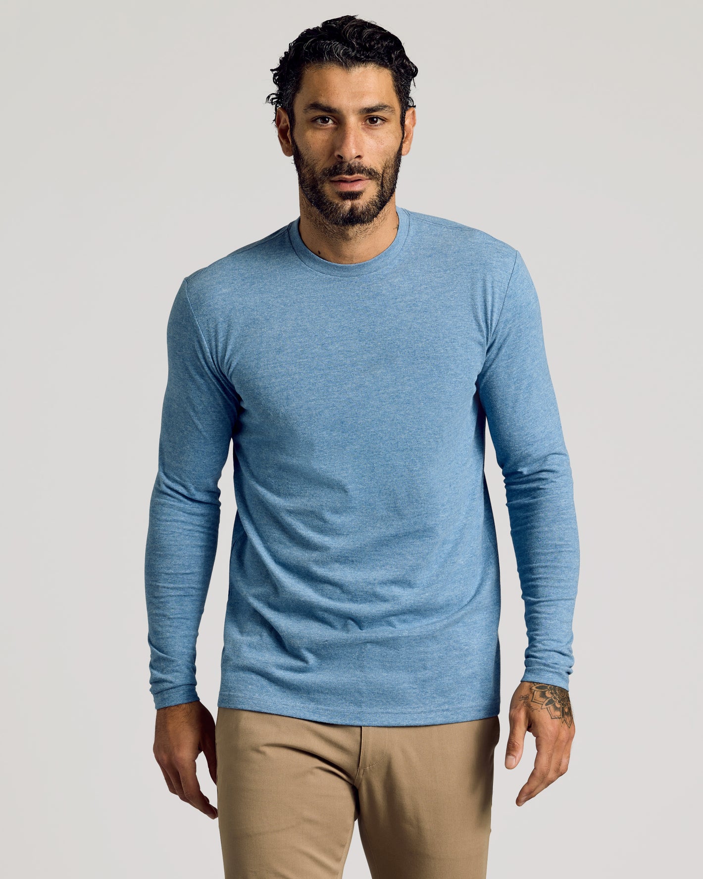 Man models Timeless Tall Long Sleeve T-Shirt in heather light blue.