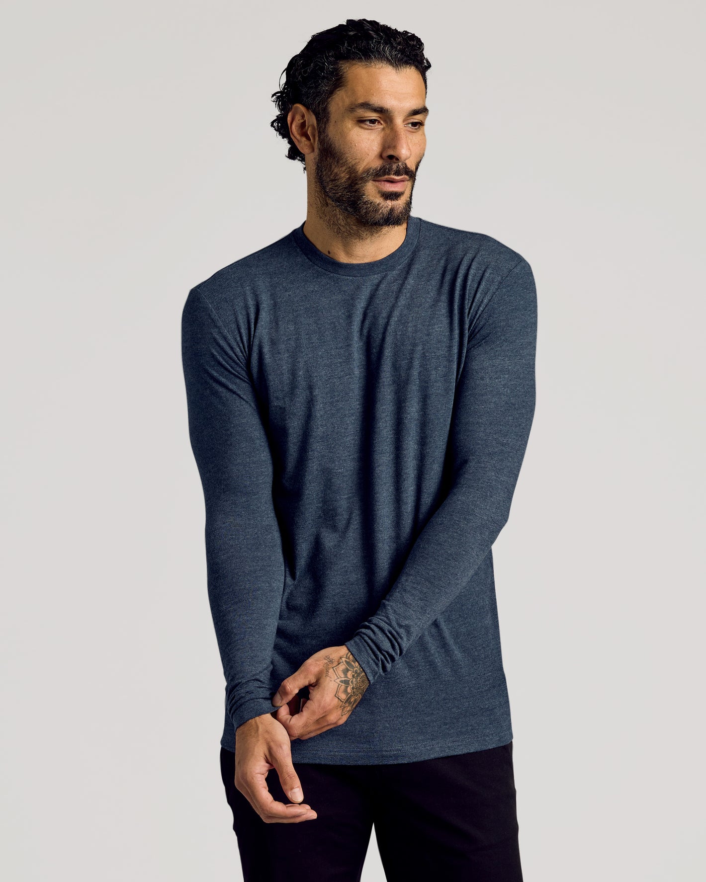 Man wearing Staple Tall Long Sleeve T-Shirt, dark-blue, fitted style.
