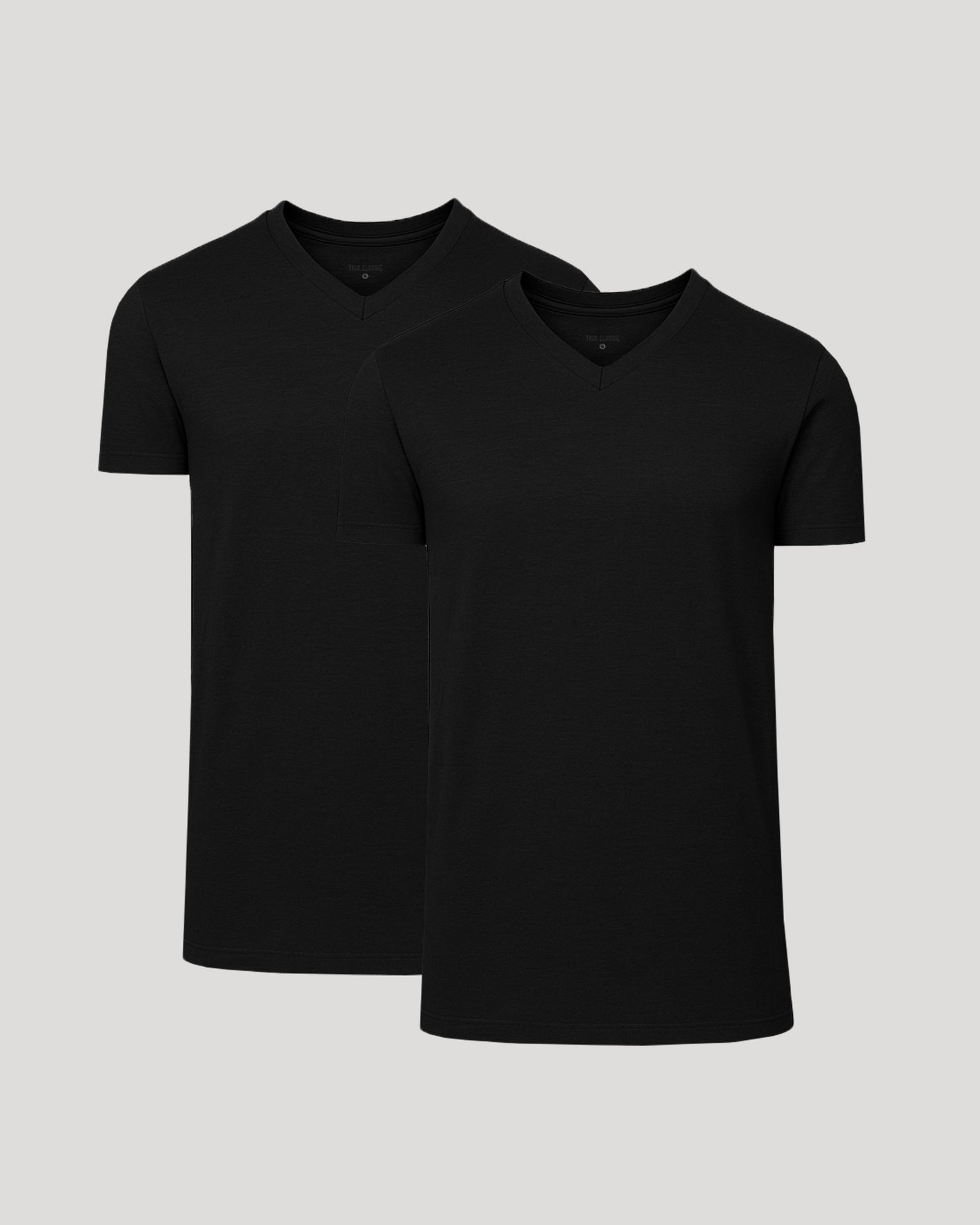 Two black V-neck t-shirts on a light gray background