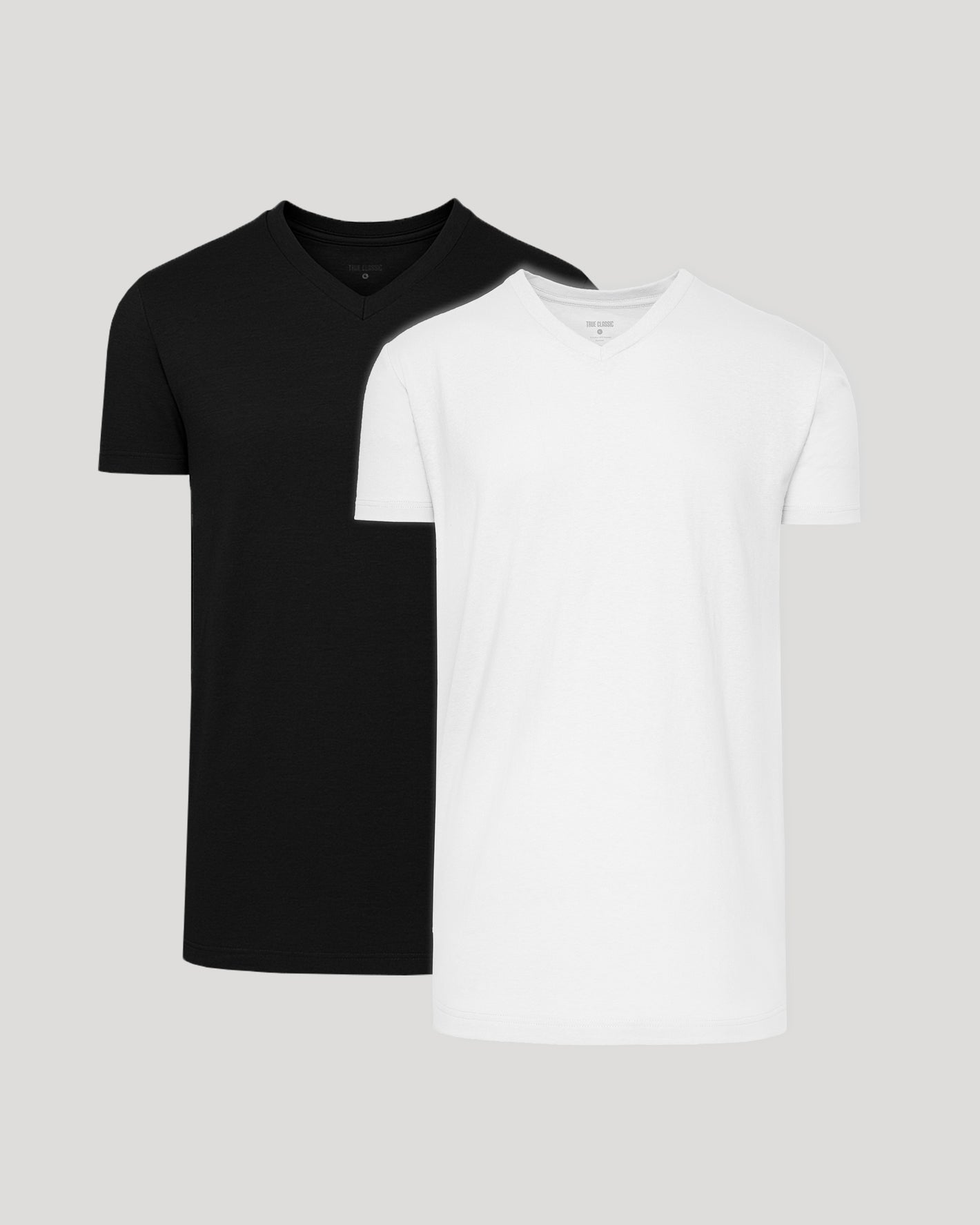 Black and white t-shirts on a light gray background