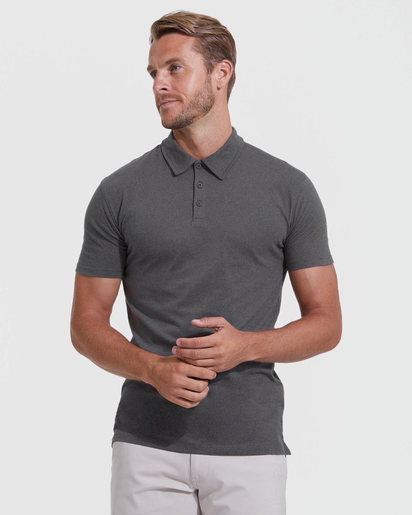 Model in The Staple Tall Classic Polo 3-Pack, dark-gray, fitted style.