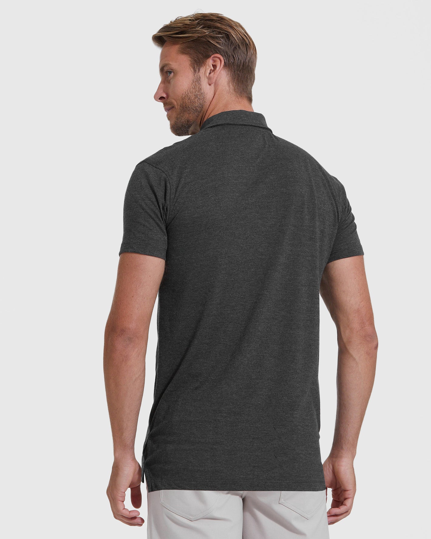 Man in Charcoal Heather Gray Short Sleeve Tall Polo, light pants.
