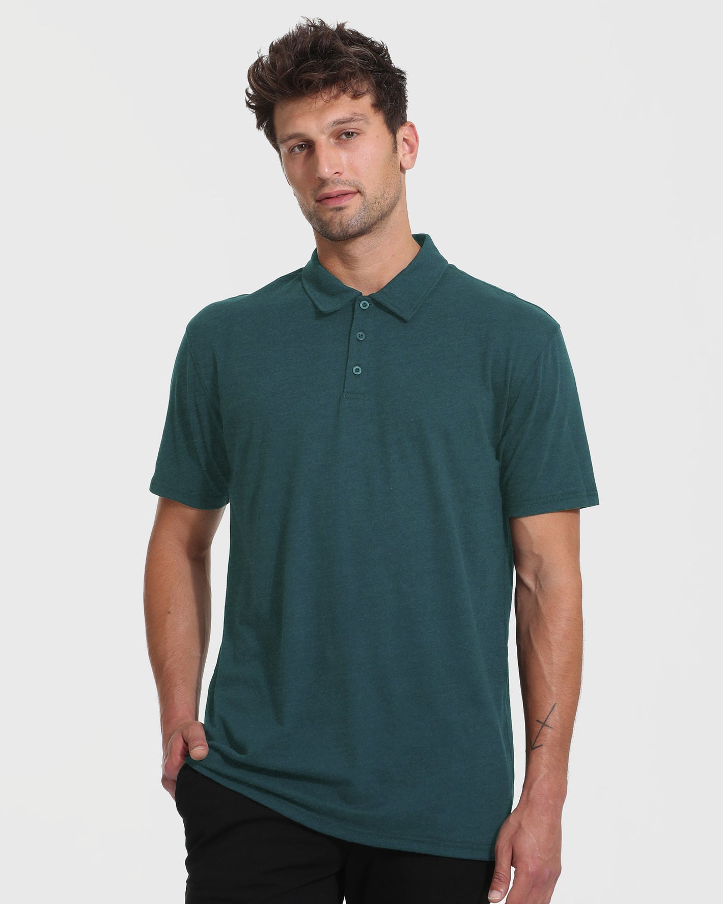 Model in Heather Seafarer Short Sleeve Tall Polo, black trousers.