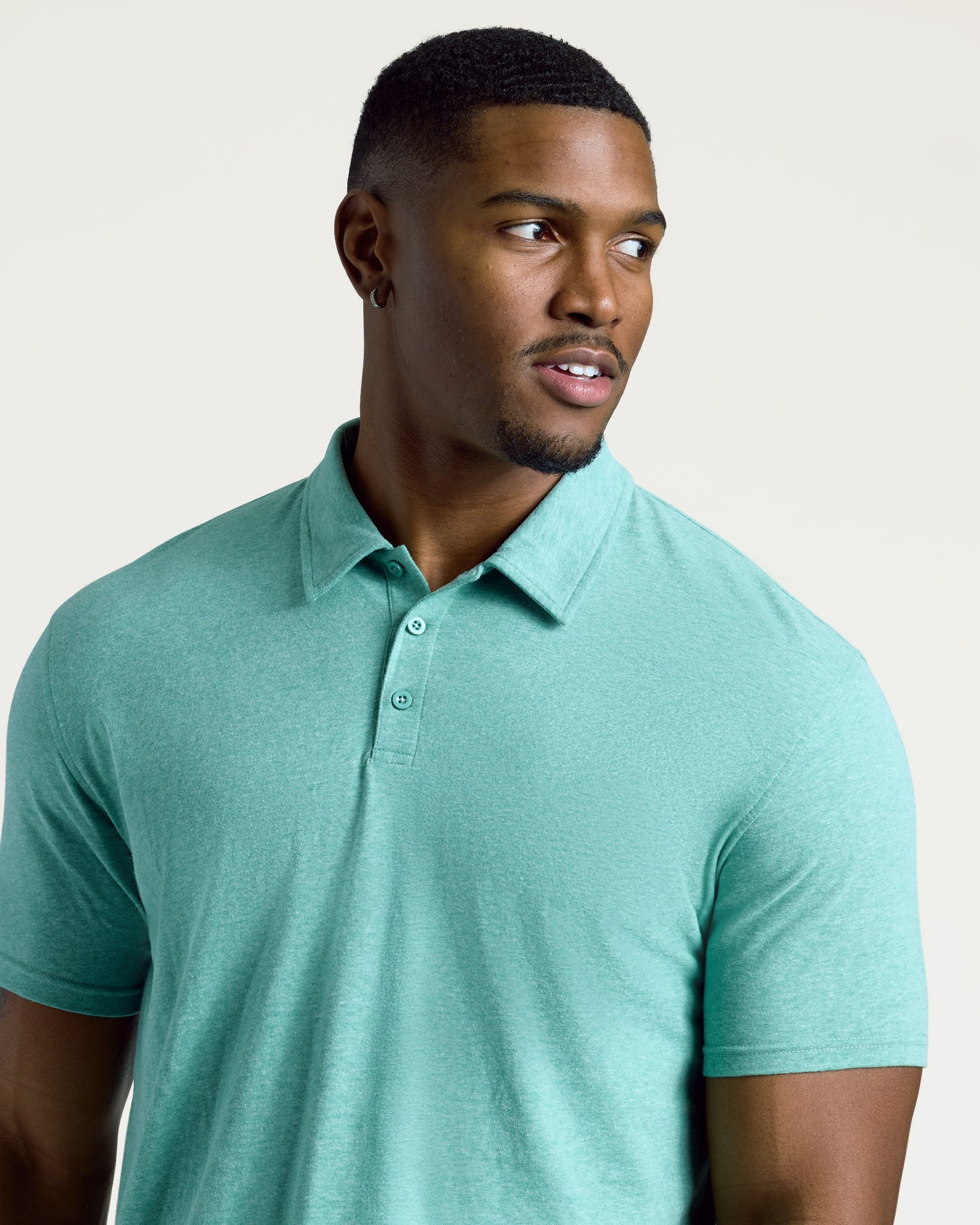 Man wearing Light Heather Greenery Short Sleeve Tall Polo.