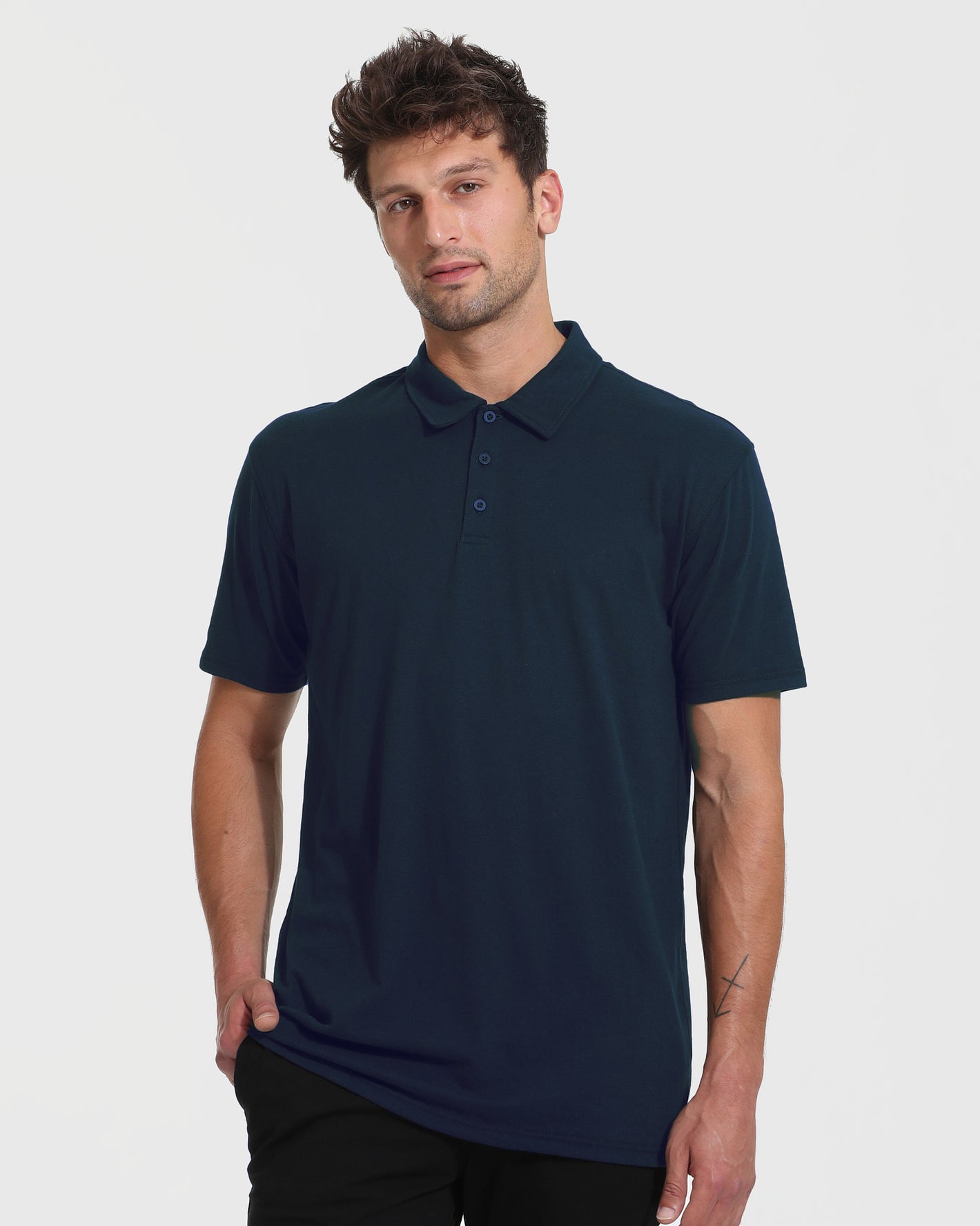 Young man models The Timeless Tall Classic Polo in navy, showcasing its fitted design.