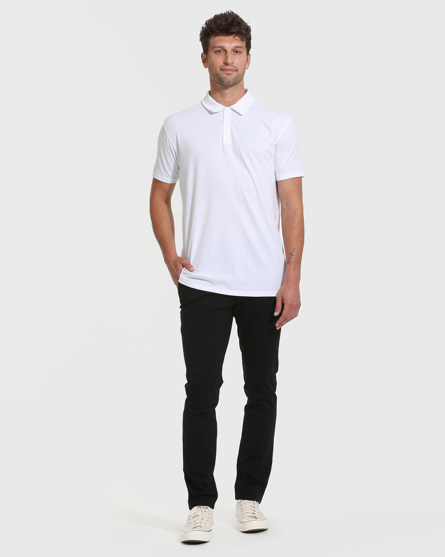 Man wearing All White Tall Classic Polo with black pants and sneakers.
