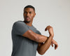 Carbon Tall Active Crew Neck 2.0 worn by man stretching arms.