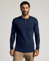 Man wearing Tall Classic Long Sleeve Henley, navy, with khaki trousers.