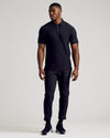 Man wearing Black Tall Active Polo from 3-Pack, full-length view.