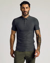 Man wearing Charcoal Heather Gray Short Sleeve Tall Active Polo, showcasing tattoos.