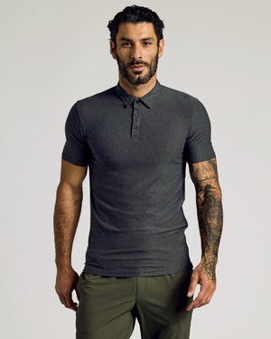 Man wearing Charcoal Heather Gray Short Sleeve Tall Active Polo, showcasing tattoos.