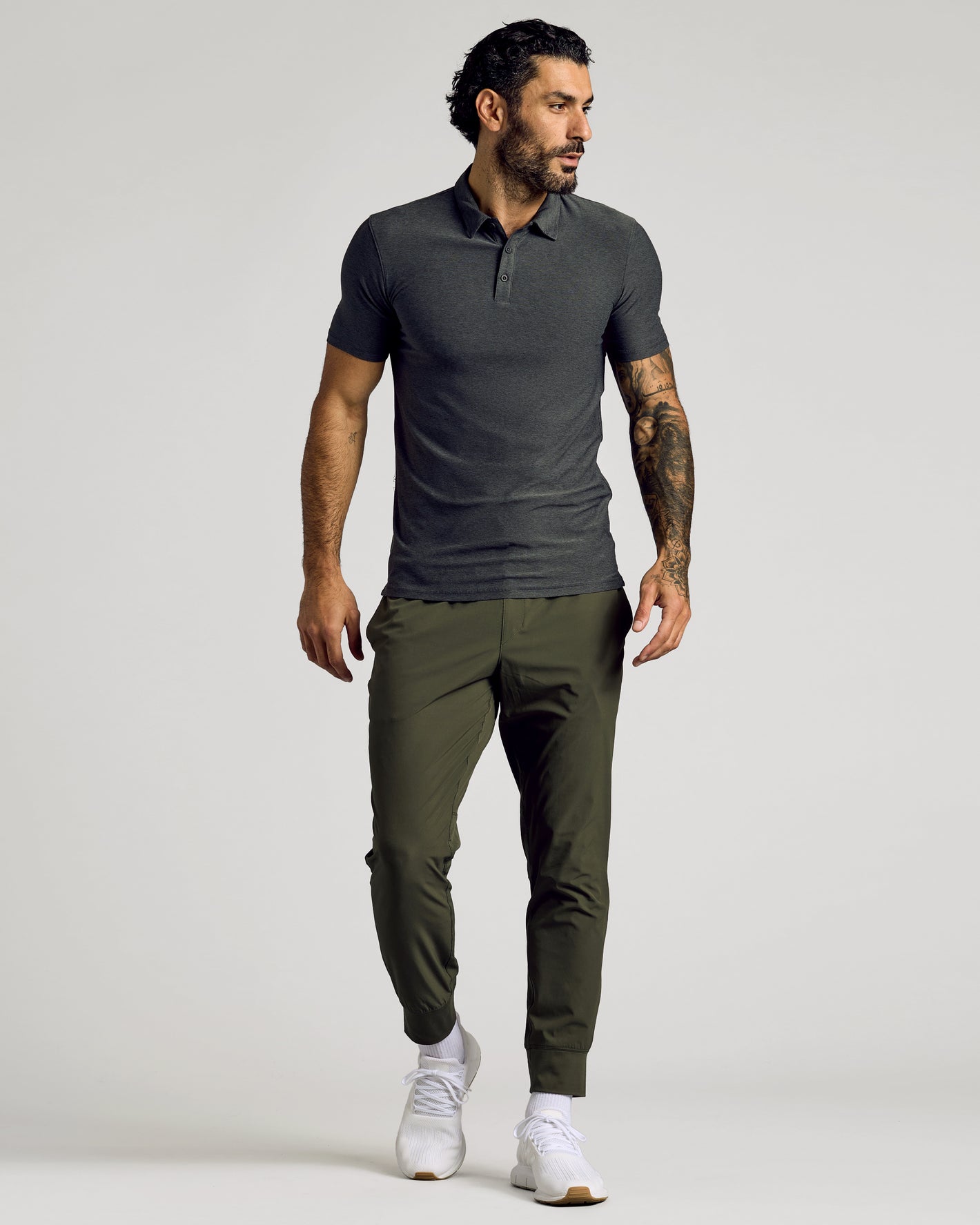 Model in Charcoal Heather Gray Short Sleeve Tall Active Polo.