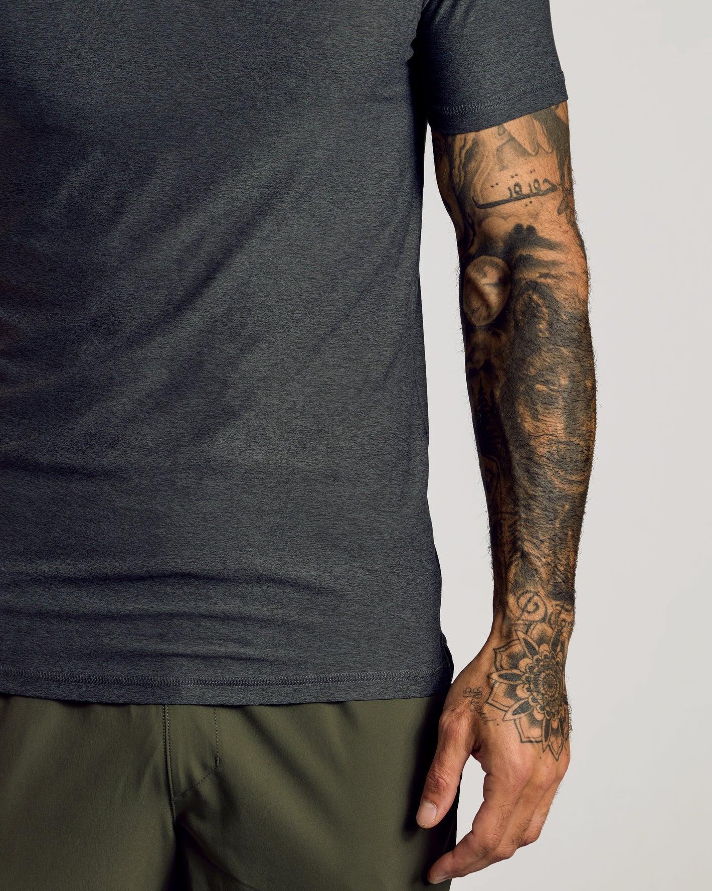 Charcoal Heather Gray Short Sleeve Tall Active Polo worn by tattooed arm.