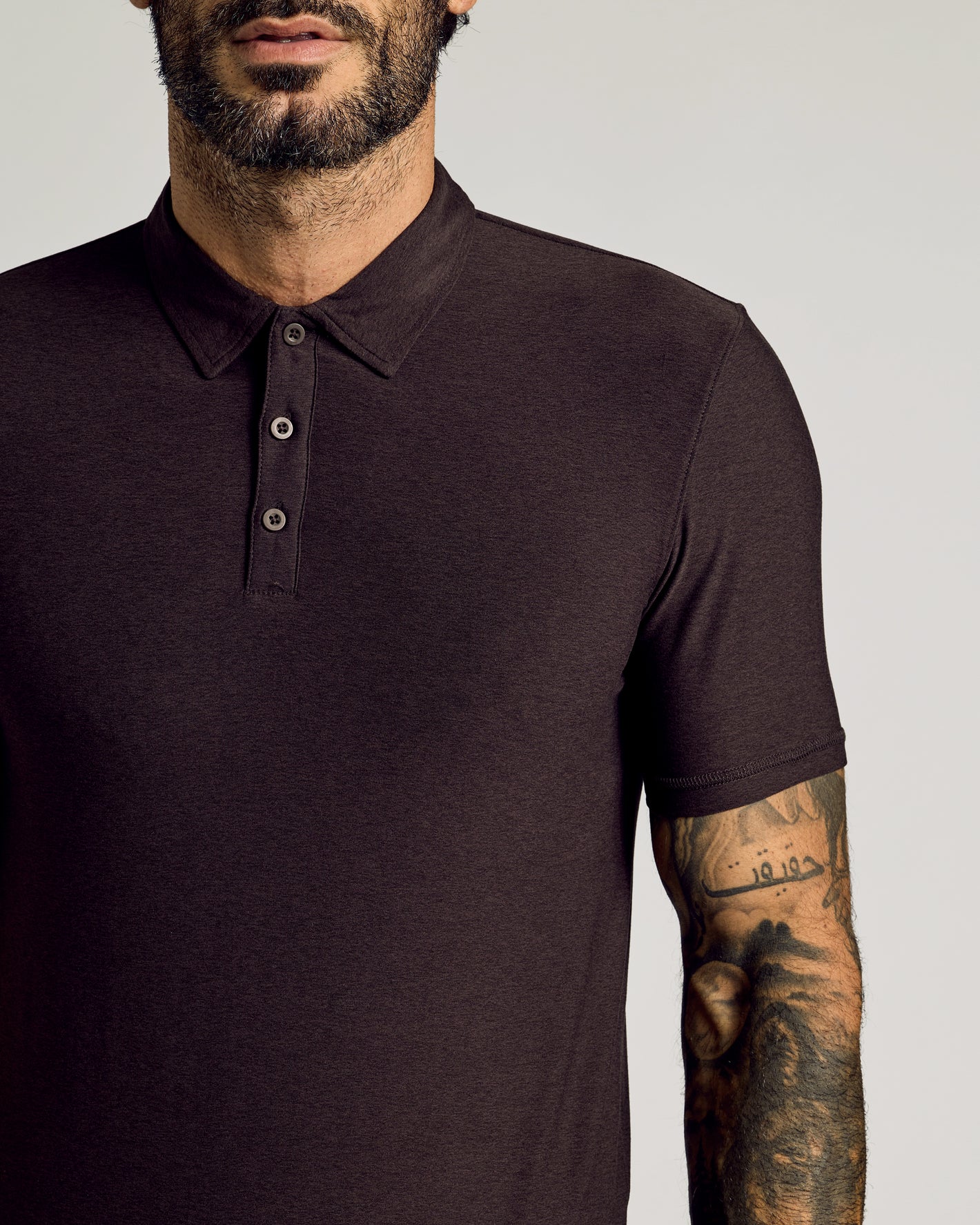 Man wearing Dark Heather Cocoa Short Sleeve Tall Active Polo.