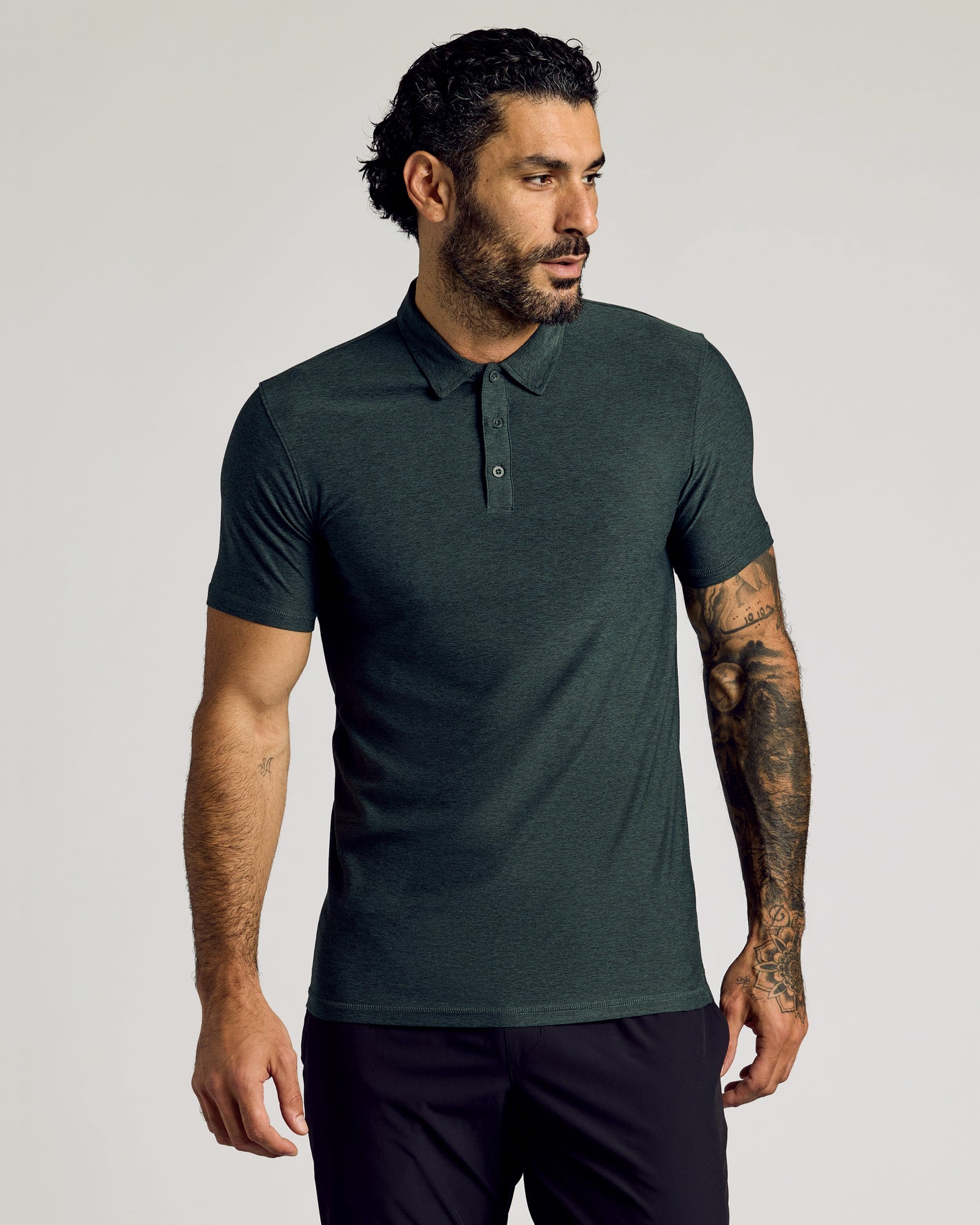 Dark Heather Forest Short Sleeve Tall Active Polo worn by tattooed model.