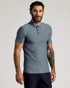 Man in Heather Navy Short Sleeve Tall Active Polo, showcasing snug fit.