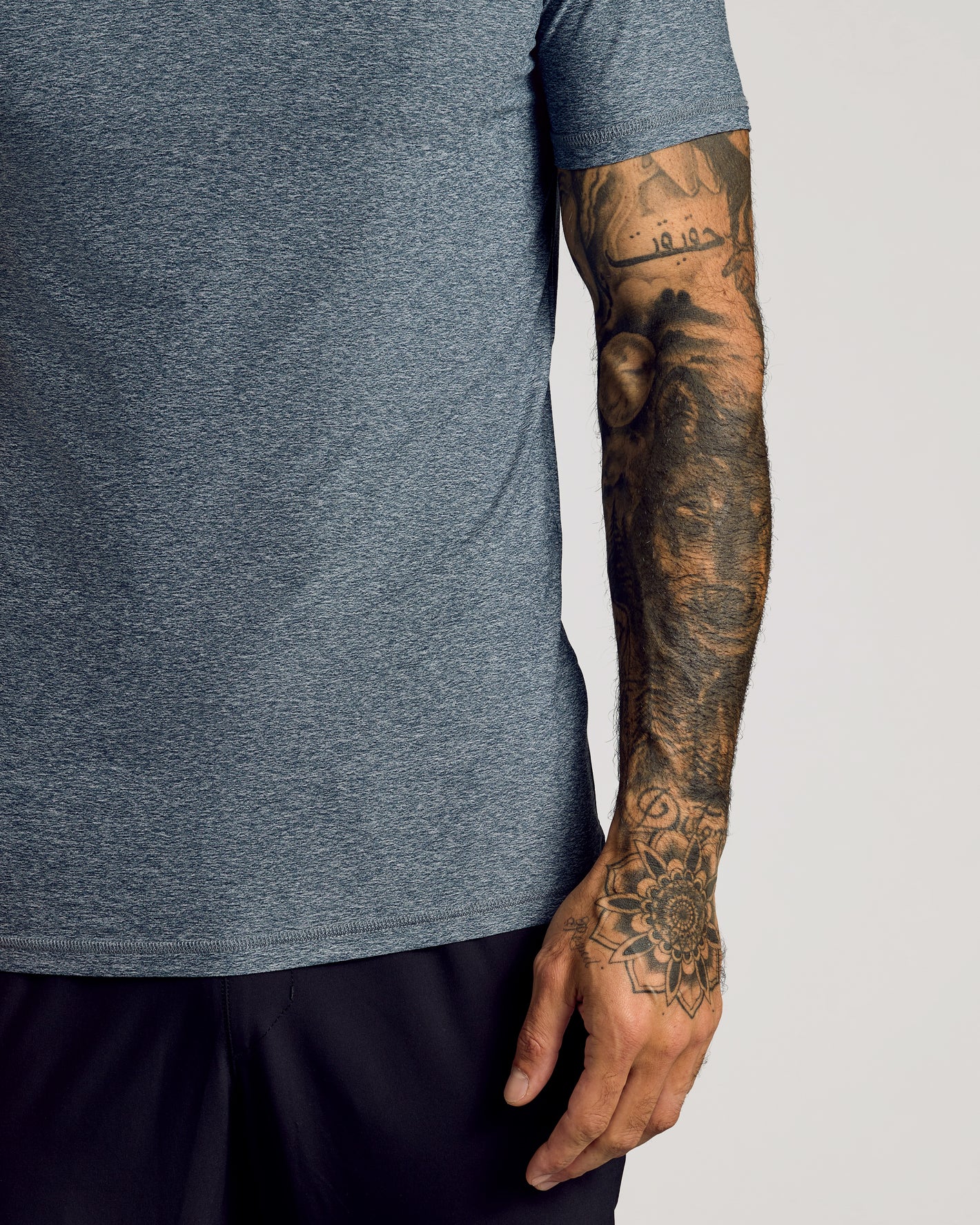 Heather Gray Short Sleeve T-shirt with tattooed arm detailing.