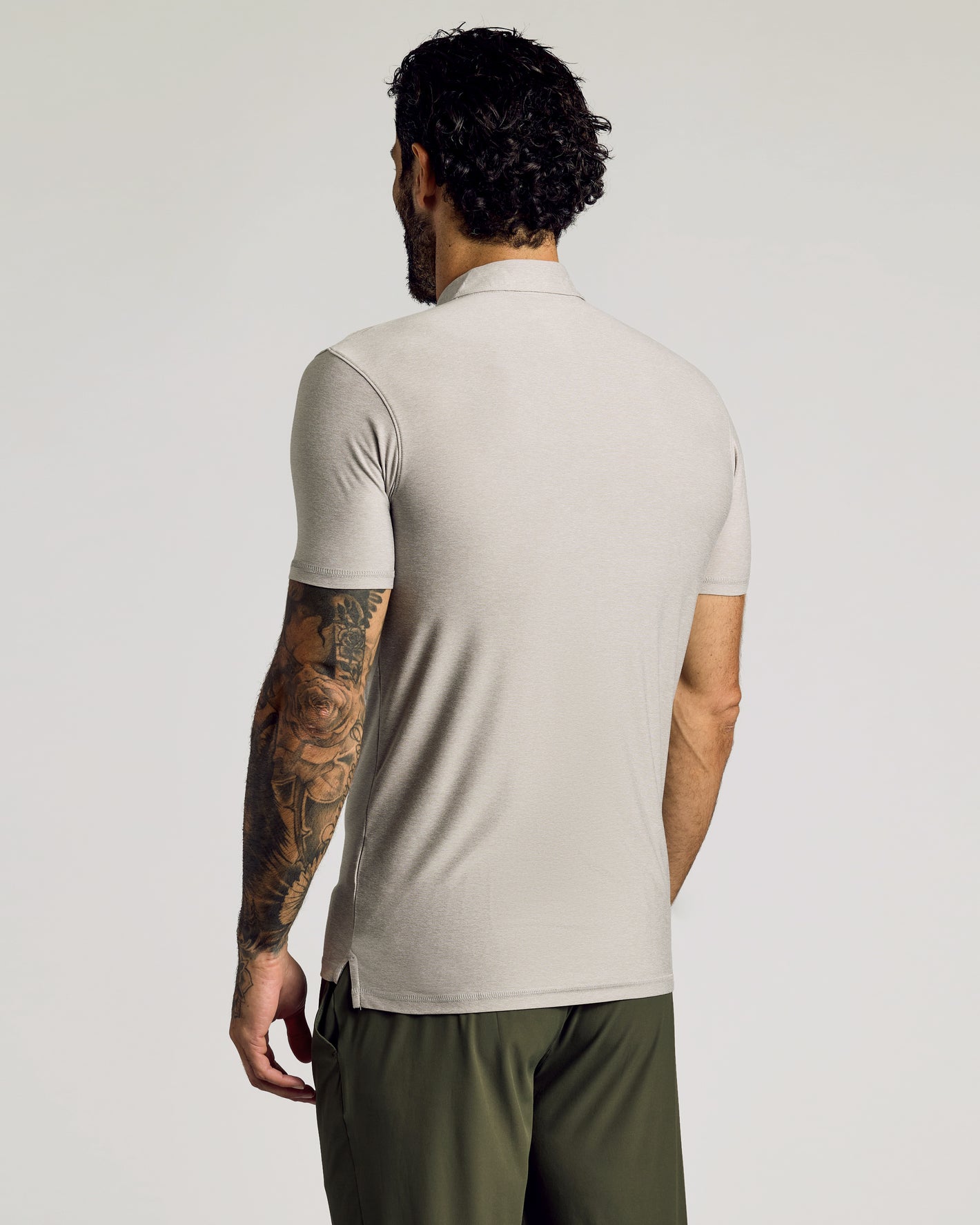 Light Heather Gray Short Sleeve Tall Active Polo worn by tattooed man.
