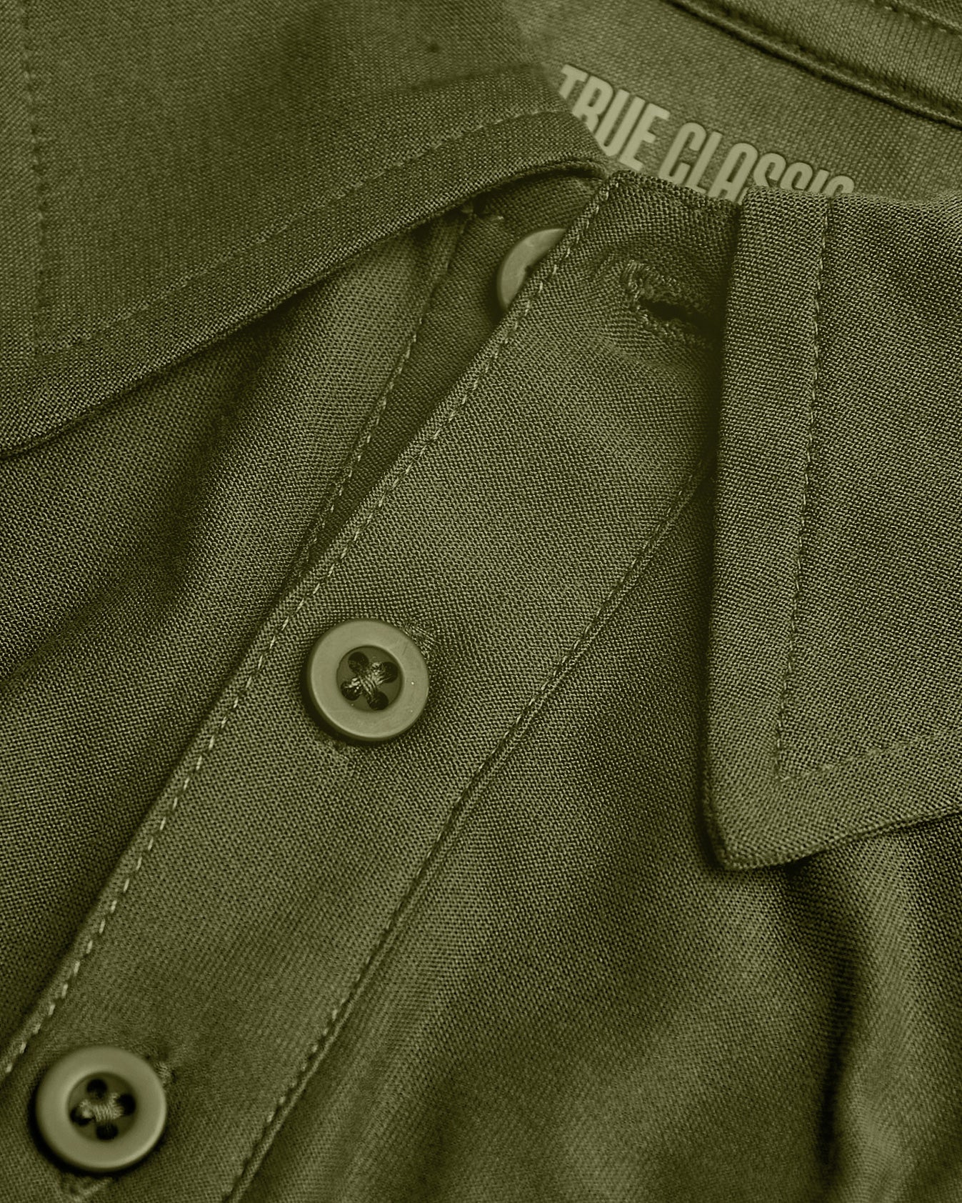Olive-green Staple Tall Active Polo close-up, showing collar and buttons.