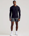 Man wearing Black Long Sleeve Tall Active Crew with gray shorts and sneakers.