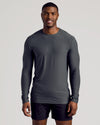 Man wearing Charcoal Heather Gray Long Sleeve Tall Active Crew and black athletic shorts.