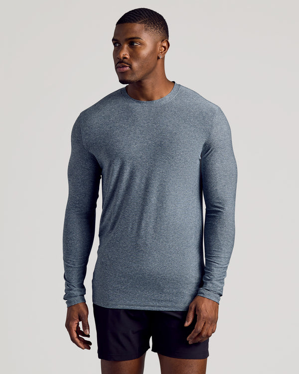 Model in Heather Navy Long Sleeve Tall Active Crew and black shorts.