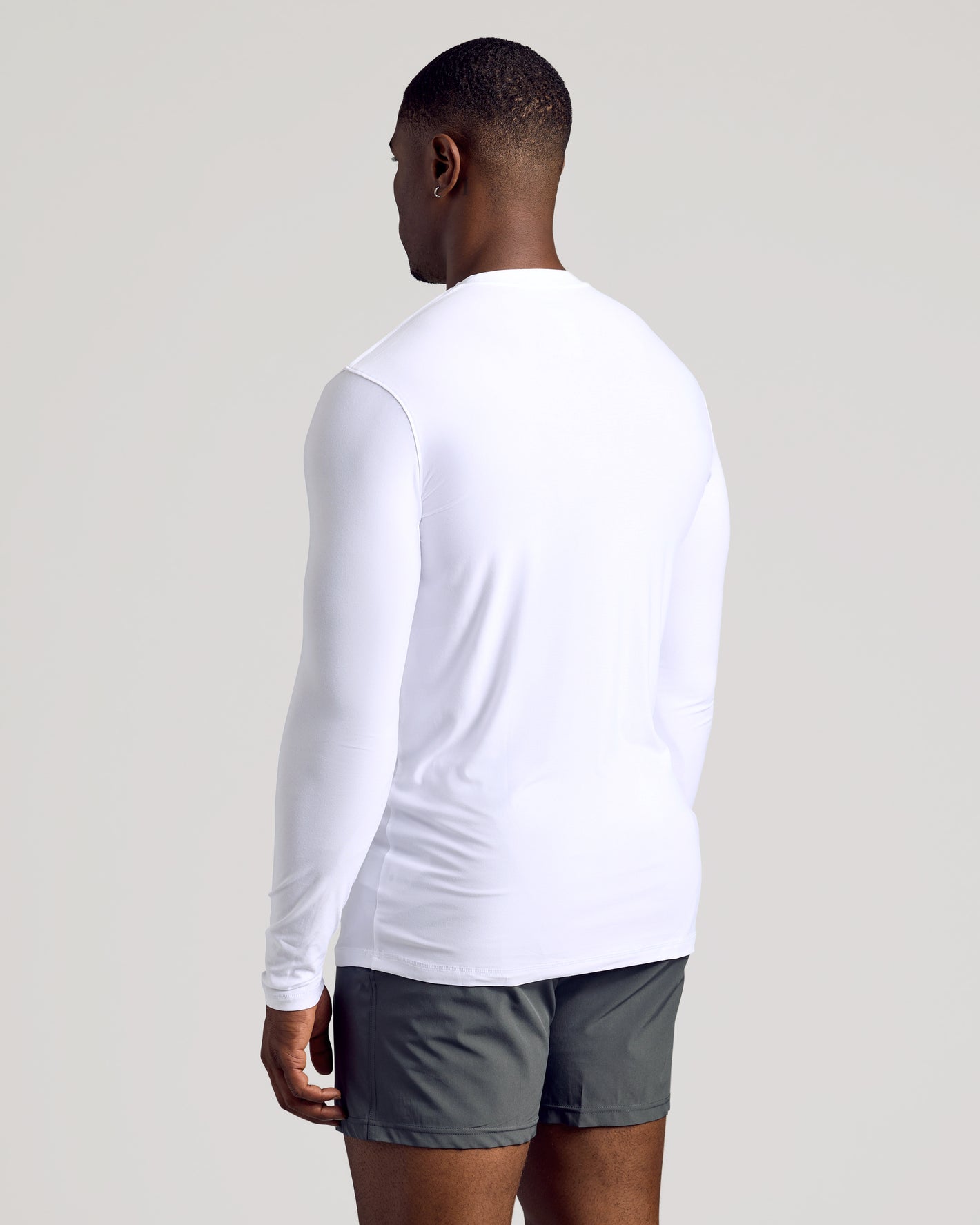Person wearing White Long Sleeve Tall Active Crew, showcasing athletic fit.