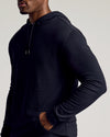 Man wearing Black & Carbon Tall Waffle Hoodie, hand in pocket.