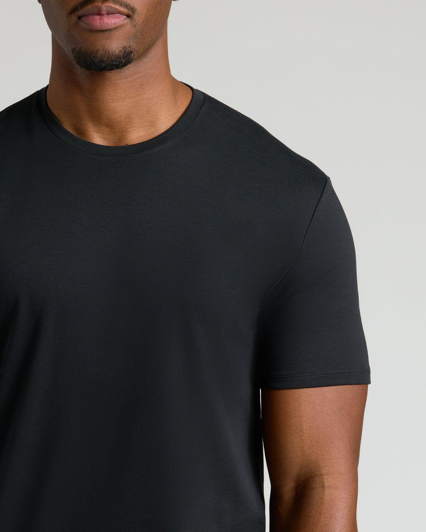 Black Tall Premium Pima Crew Neck on model, showcasing neckline and shoulders.
