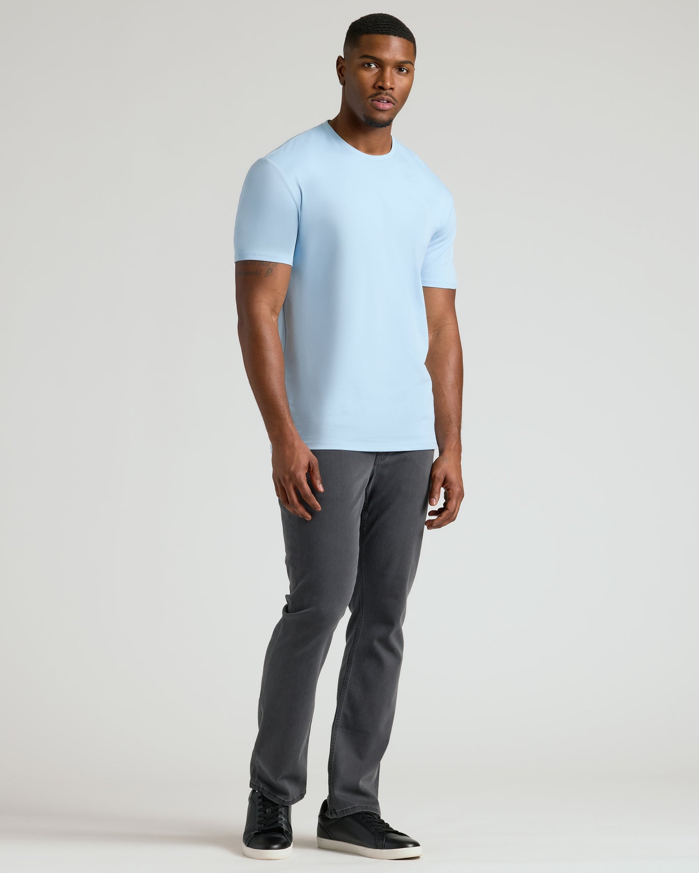 Young man wearing the Ether Tall Premium Pima Crew Neck.