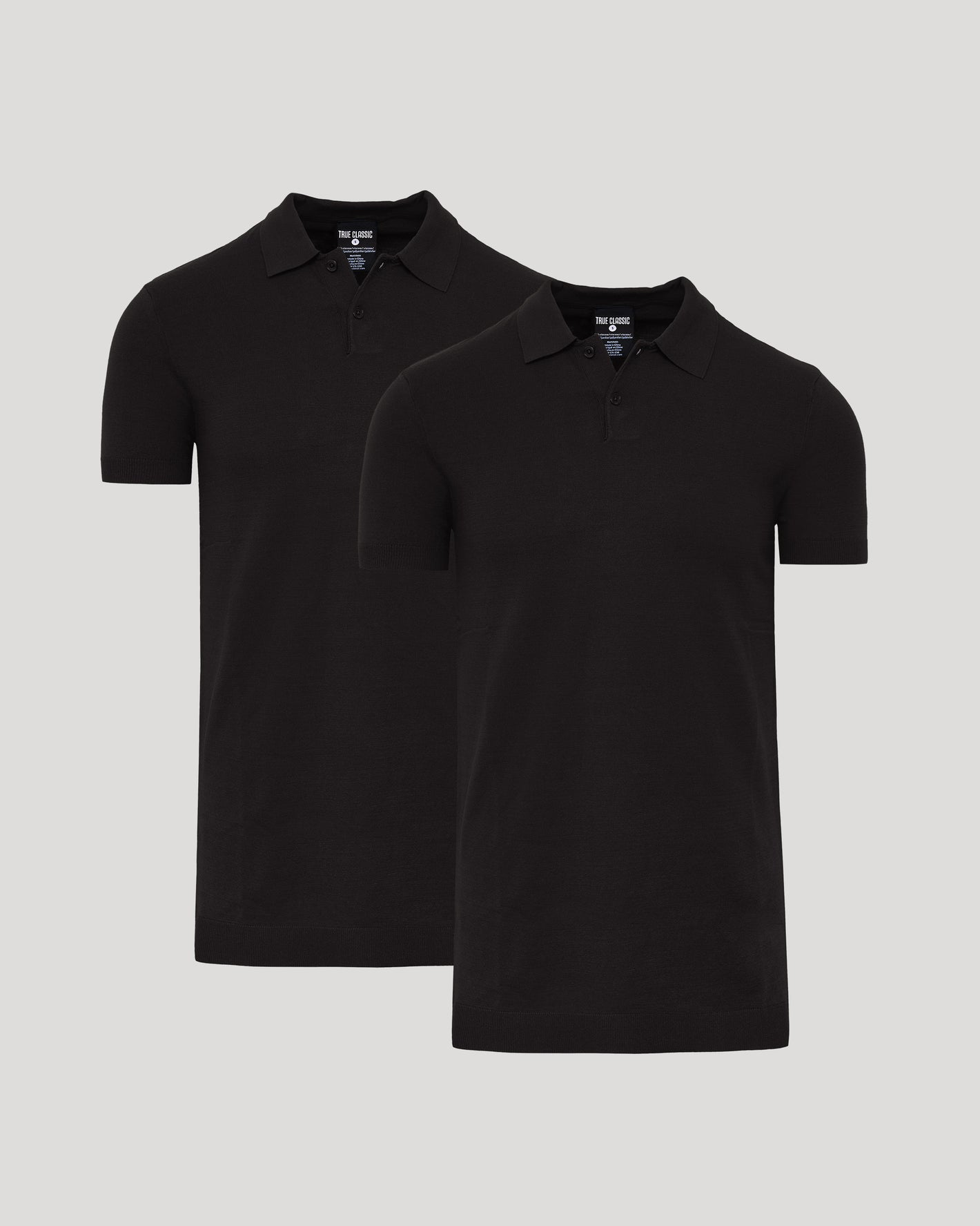 Two black polo shirts on a light gray background
