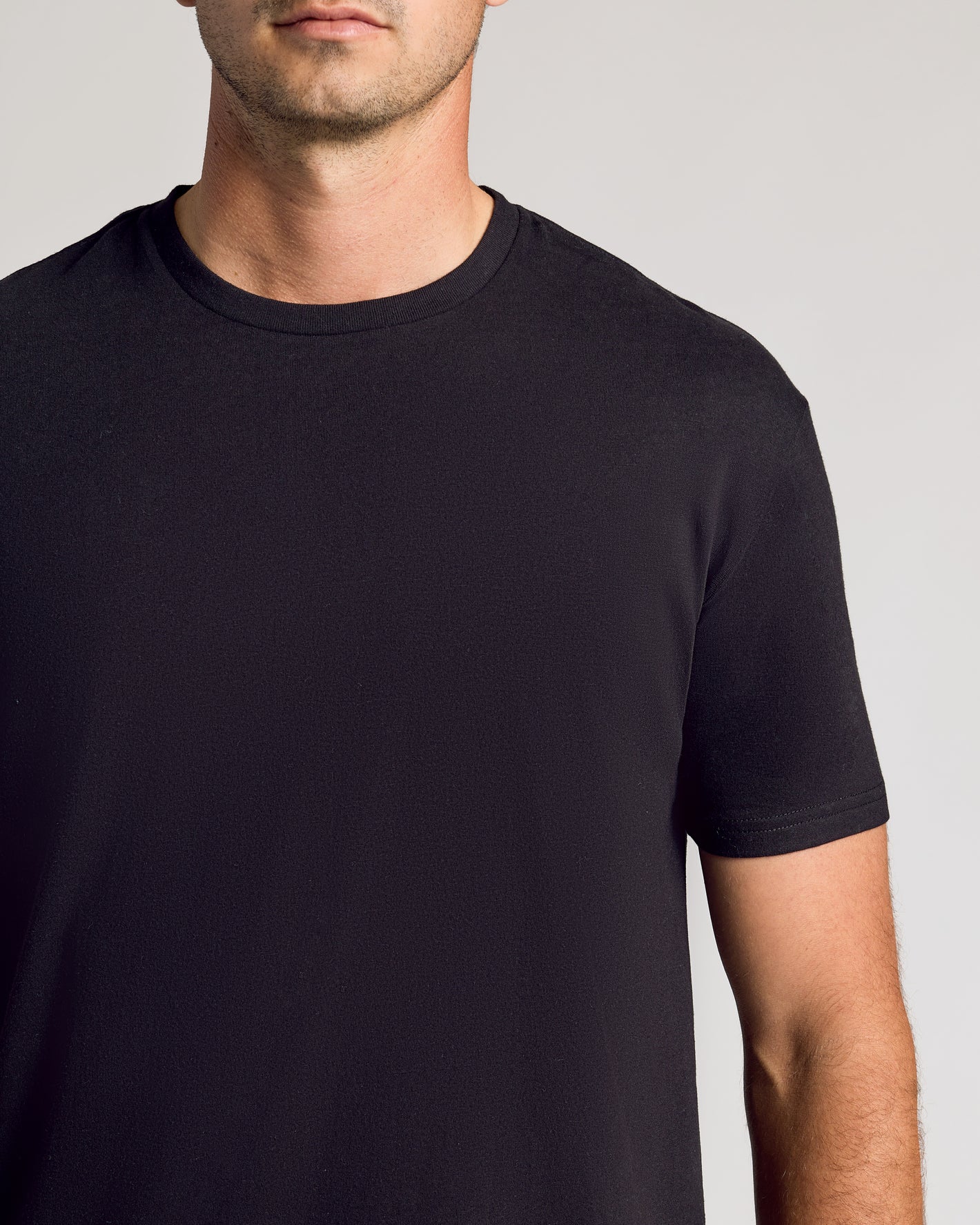 All Black Short Sleeve Tall Curved Hem Crew T-shirt worn by male model.